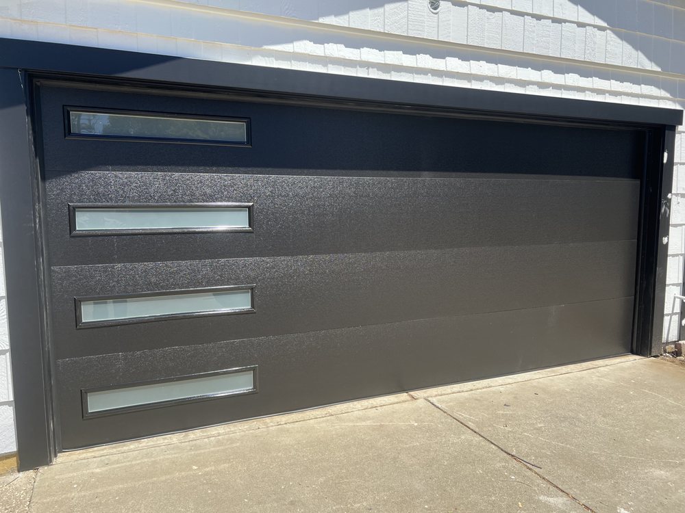 Charcoal modern flush-panel garage door with horizontal window slats